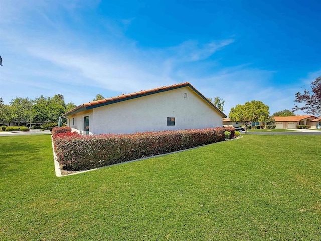 1074 Merrill Cir, Hemet, CA 92545 - view of property exterior featuring stucco siding, a lawn, and a tiled roof