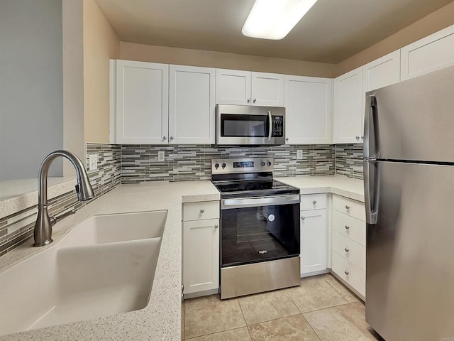 1074 Merrill Cir, Hemet, CA 92545 - kitchen featuring stainless steel appliances, a sink, light countertops, white cabinetry, and tasteful backsplash