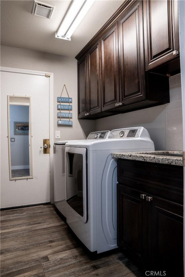 6338 Countryside Ct, Orland, CA 95963 - laundry room with washer and clothes dryer, cabinet space, and dark wood finished floors