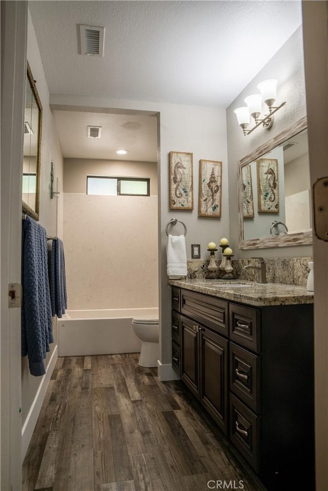 6338 Countryside Ct, Orland, CA 95963 - bathroom featuring wood finished floors, toilet, vanity, shower / tub combination, and a chandelier