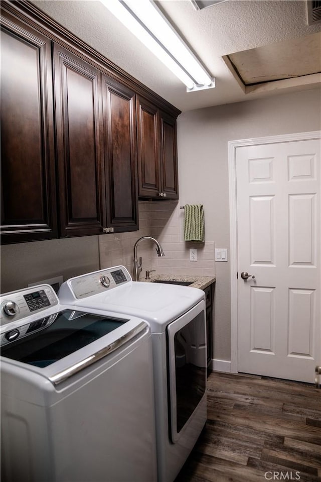 6338 Countryside Ct, Orland, CA 95963 - laundry room featuring washing machine and clothes dryer, cabinet space, and dark wood-type flooring