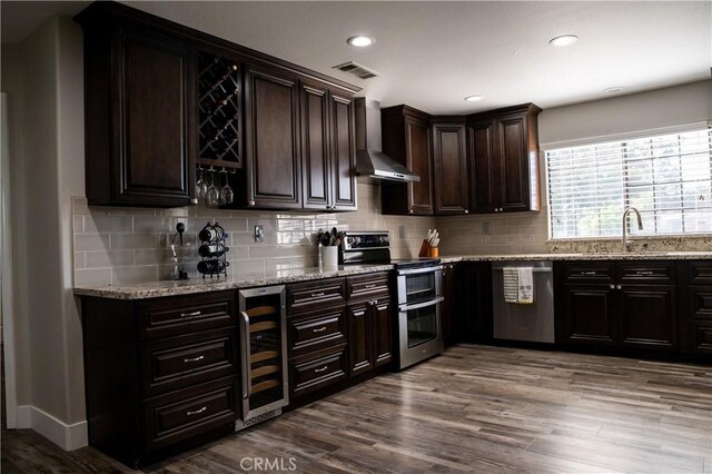 6338 Countryside Ct, Orland, CA 95963 - bar with wall chimney exhaust hood, appliances with stainless steel finishes, beverage cooler, a sink, and dark wood-style flooring