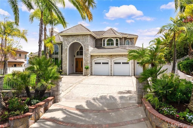 2638 Highridge Dr, Chino Hills, CA 91709 - view of front facade with stone siding, driveway, an attached garage, a tile roof, and stucco siding