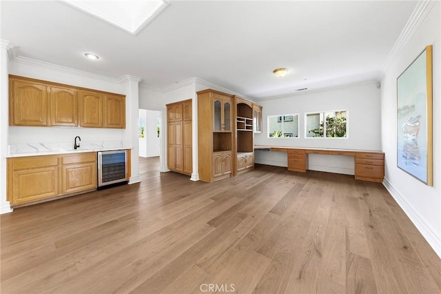 2638 Highridge Dr, Chino Hills, CA 91709 - kitchen with beverage cooler, a sink, plenty of natural light, light wood finished floors, and ornamental molding