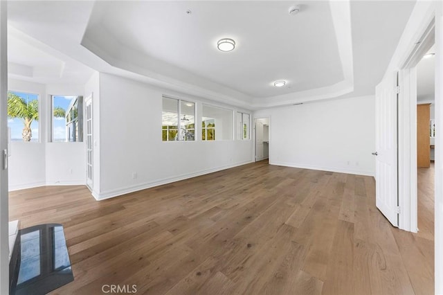 2638 Highridge Dr, Chino Hills, CA 91709 - unfurnished living room featuring a tray ceiling, wood finished floors, and baseboards