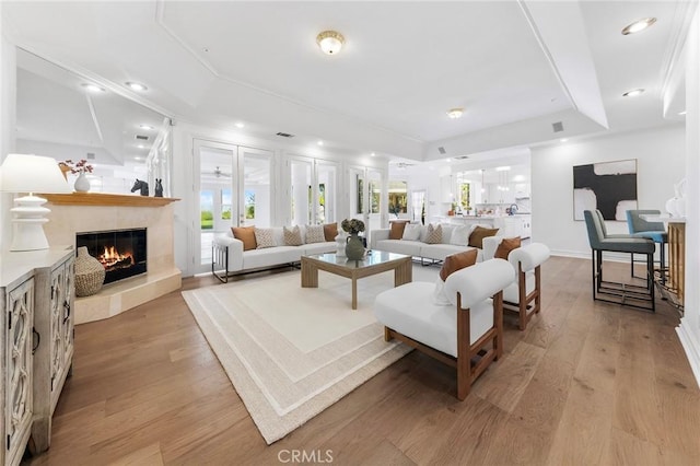 2638 Highridge Dr, Chino Hills, CA 91709 - living area featuring a glass covered fireplace, a tray ceiling, light wood finished floors, and recessed lighting
