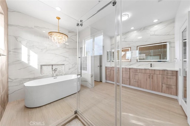2638 Highridge Dr, Chino Hills, CA 91709 - full bathroom with a soaking tub, a chandelier, vanity, tile walls, and recessed lighting