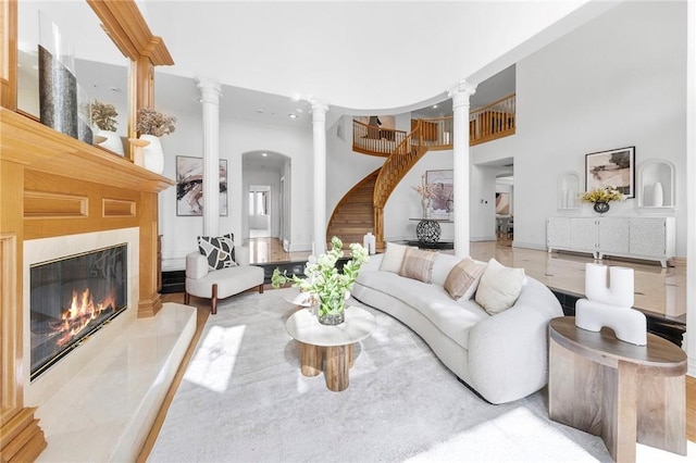 2638 Highridge Dr, Chino Hills, CA 91709 - living room featuring decorative columns, a towering ceiling, a glass covered fireplace, recessed lighting, and stairway