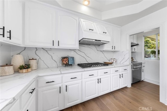2638 Highridge Dr, Chino Hills, CA 91709 - kitchen featuring custom exhaust hood, stainless steel gas cooktop, light wood-style flooring, light stone countertops, and range with gas cooktop