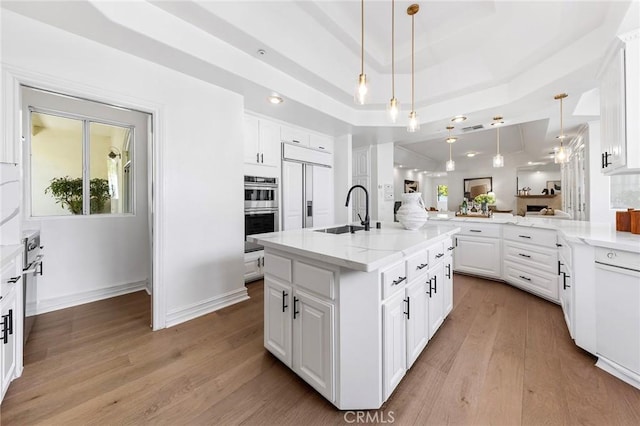 2638 Highridge Dr, Chino Hills, CA 91709 - kitchen with a sink, paneled fridge, double oven, light wood-style floors, and white cabinetry