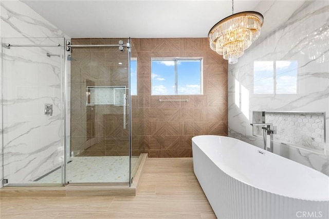 2638 Highridge Dr, Chino Hills, CA 91709 - full bathroom featuring a chandelier, a freestanding bath, a stall shower, and tile walls