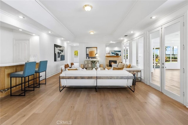2638 Highridge Dr, Chino Hills, CA 91709 - living room featuring light wood finished floors, a tray ceiling, crown molding, a lit fireplace, and recessed lighting
