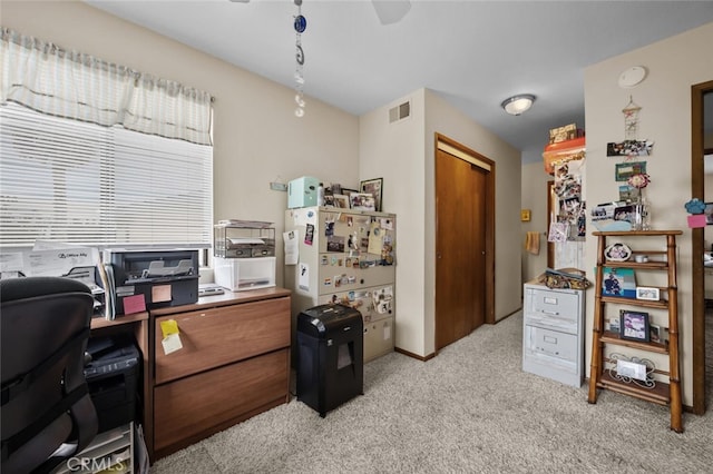 office area featuring light colored carpet and a ceiling fan
