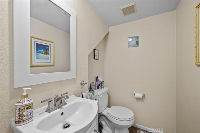 half bath featuring a sink and toilet