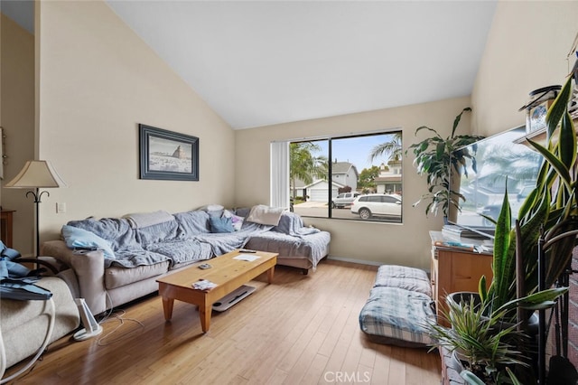 living room with vaulted ceiling and wood finished floors