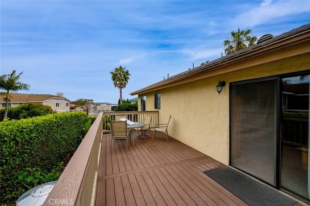 wooden terrace with outdoor dining area