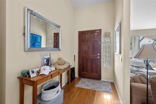 foyer with wood finished floors and baseboards