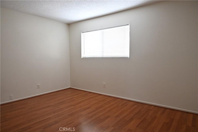 25258 Taylor St, Loma Linda, CA 92354 - spare room featuring wood finished floors, baseboards, and a textured ceiling
