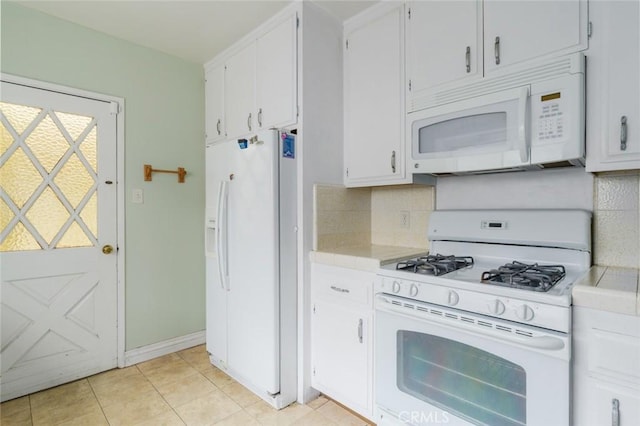 6016 Wilson Ave, South Gate, CA 90280 - kitchen featuring white appliances, decorative backsplash, white cabinets, and light tile patterned floors