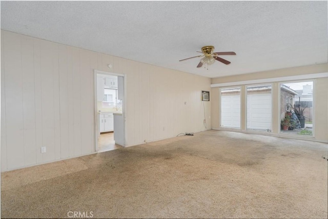 6016 Wilson Ave, South Gate, CA 90280 - empty room featuring a ceiling fan, carpet, and a textured ceiling