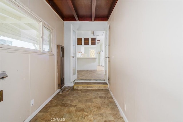 6016 Wilson Ave, South Gate, CA 90280 - corridor with plenty of natural light, stone finish flooring, and baseboards