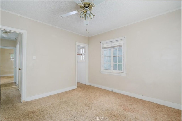 6016 Wilson Ave, South Gate, CA 90280 - carpeted spare room with a ceiling fan, baseboards, a textured ceiling, crown molding, and attic access