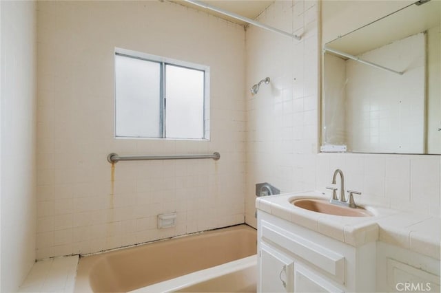 6016 Wilson Ave, South Gate, CA 90280 - full bath with decorative backsplash, vanity, tile walls, and shower / tub combination