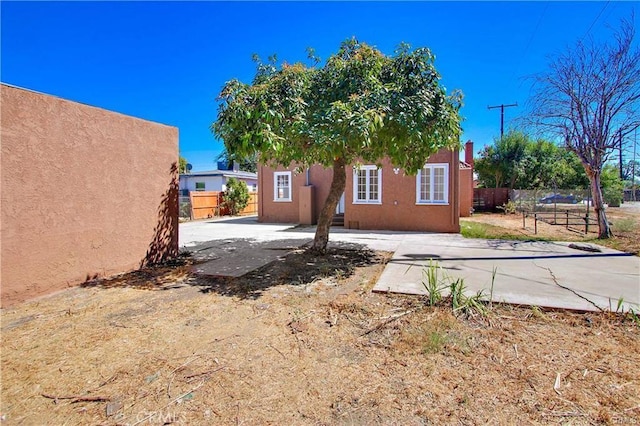443 W Tichenor St, Compton, CA 90220 - back of house featuring fence, stucco siding, and an outbuilding