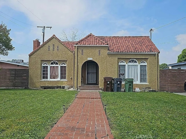 443 W Tichenor St, Compton, CA 90220 - mediterranean / spanish-style home featuring a tiled roof, stucco siding, and a chimney