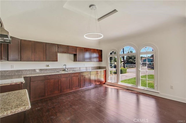 443 W Tichenor St, Compton, CA 90220 - kitchen featuring a sink, dark wood-style flooring, pendant lighting, and baseboards
