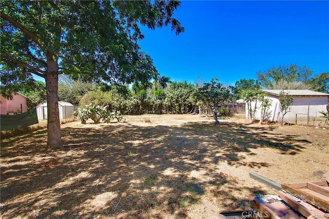 443 W Tichenor St, Compton, CA 90220 - view of yard featuring a shed, fence, and an outbuilding