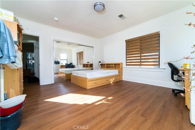 1023 S Wilton Pl, Los Angeles, CA 90019 - bedroom featuring wood finished floors, baseboards, ornamental molding, and a closet