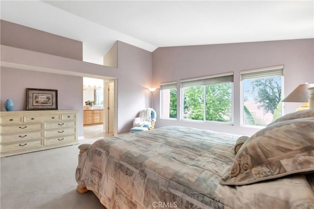 bedroom with lofted ceiling, multiple windows, and carpet floors