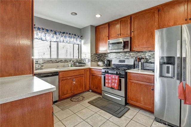 13580 Foothill Blvd Unit 1, Sylmar, CA 91342 - kitchen featuring appliances with stainless steel finishes, light countertops, backsplash, light tile patterned floors, and recessed lighting