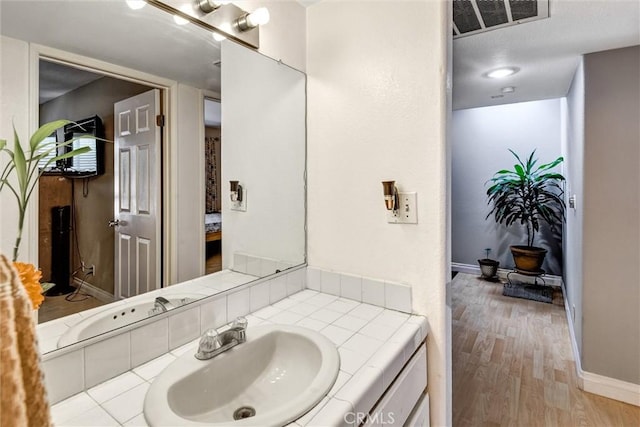 13580 Foothill Blvd Unit 1, Sylmar, CA 91342 - bathroom with wood finished floors, vanity, and baseboards