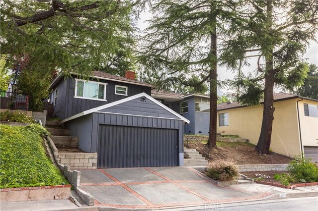 3035 Highridge Rd, La Crescenta, CA 91214 - view of front of property featuring stairs, a chimney, concrete driveway, and an attached garage