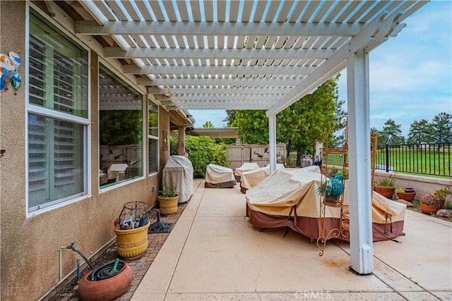 view of patio / terrace with a fenced backyard, a grill, and a pergola