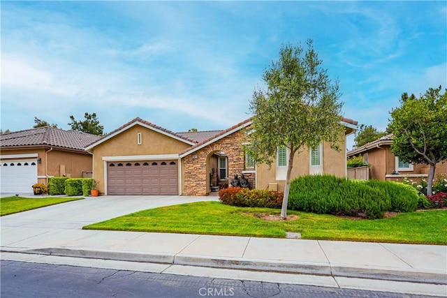 ranch-style home featuring stucco siding, a garage, stone siding, a front lawn, and concrete driveway