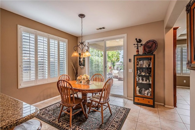 dining space with plenty of natural light, light tile patterned floors, and baseboards
