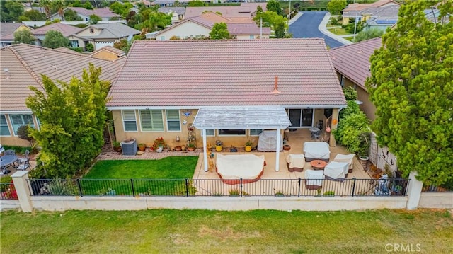 back of property featuring a tile roof, a patio area, central AC unit, stucco siding, and a residential view