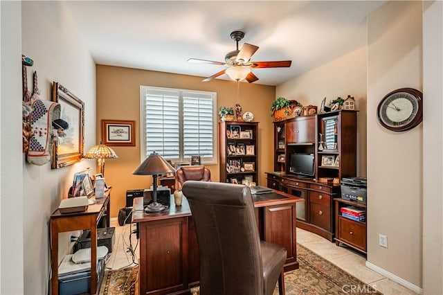 office area with a ceiling fan, light tile patterned floors, and baseboards