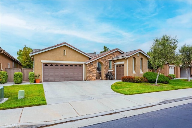 ranch-style house with stucco siding, a garage, concrete driveway, a tiled roof, and stone siding