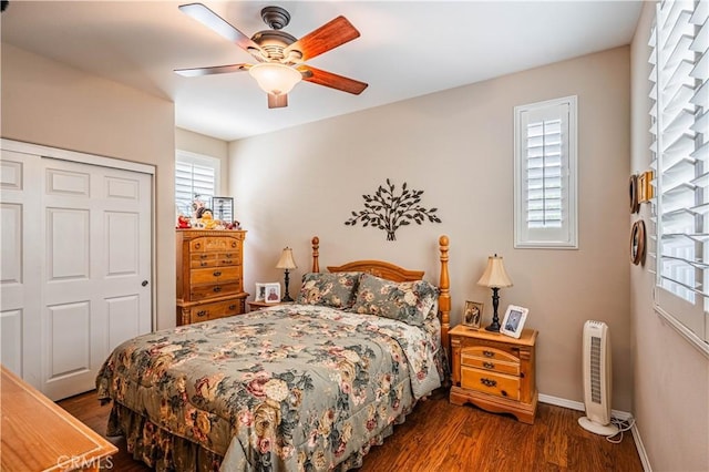 bedroom with wood finished floors, baseboards, a closet, and a ceiling fan