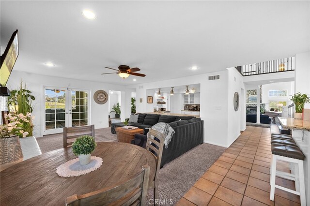 dining space featuring french doors, light tile patterned flooring, a ceiling fan, healthy amount of natural light, and recessed lighting