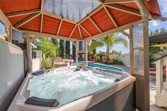 view of patio featuring a hot tub and a fenced backyard