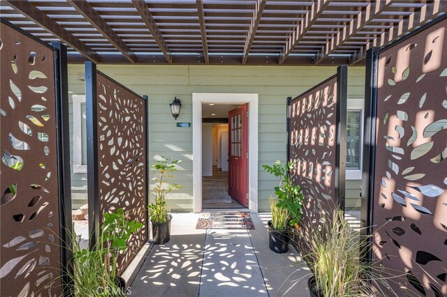 doorway to property featuring a pergola