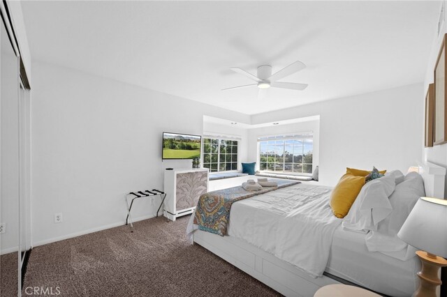 carpeted bedroom featuring ceiling fan and baseboards