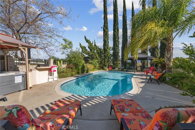 outdoor pool featuring a gazebo and a patio area