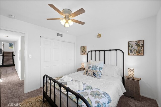 bedroom featuring carpet floors, a closet, baseboards, and ceiling fan