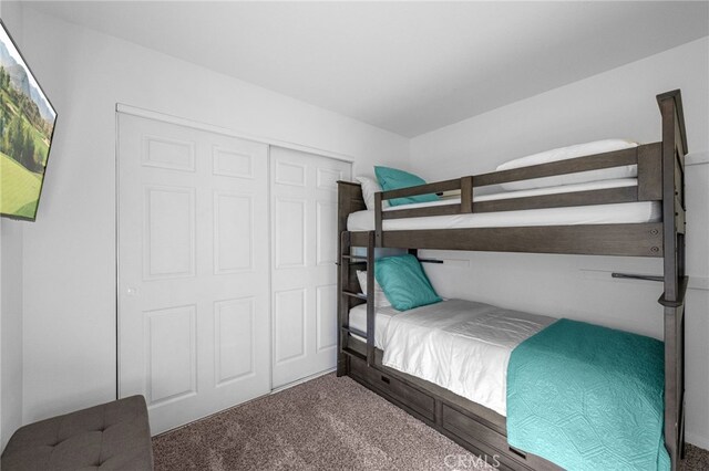 bedroom with carpet and a closet